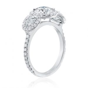 Engagament ring open ring angled view with three round diamonds each with thin diamond halo on white background