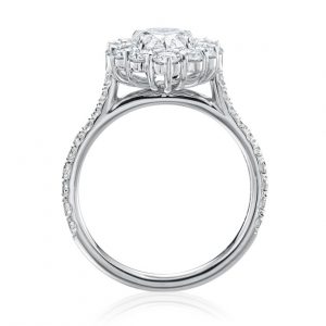 diamond engagement ring with pear cut diamond center and round diamonds in the halo. face in view with white background